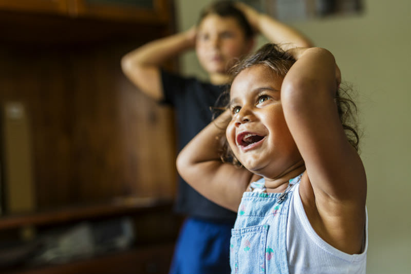 Happy Young Australian Aboriginal girl learning to sing and dance. Stock photo / Getty
