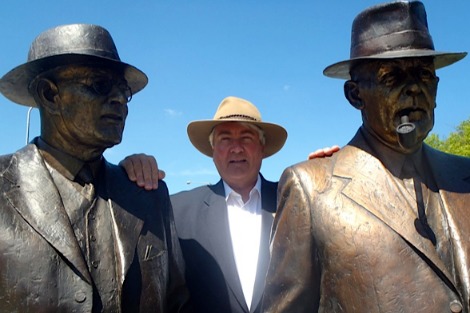 Frank Brennan stands between statues of Chifley and Curtin